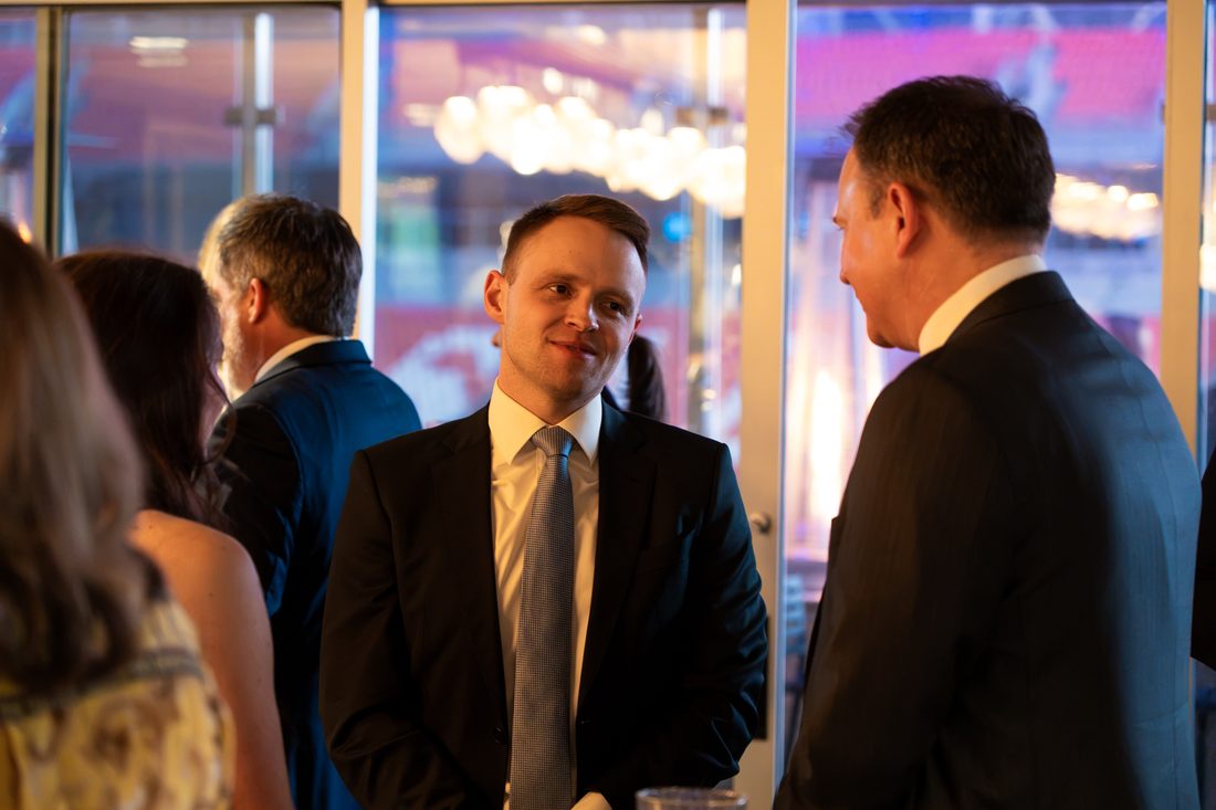 Guests in conversation at Blue Tie Gala